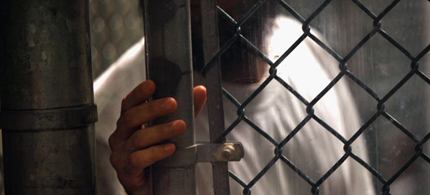 A detainee stands at a fence inside the detention center in September 2010 in Guantanamo Bay, Cuba. (photo: John Moore/Getty Images)